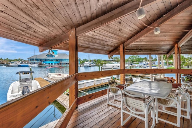 deck with boat lift, a boat dock, and a water view
