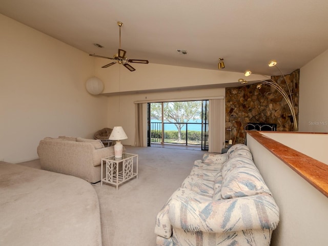 7085 Sunset Dr S Unit A, Saint Petersburg, FL 33707 - living room featuring vaulted ceiling, carpet, a ceiling fan, and a fireplace