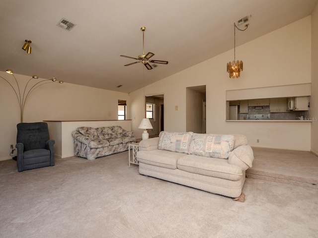 7085 Sunset Dr S Unit A, Saint Petersburg, FL 33707 - living area with carpet, lofted ceiling, ceiling fan, and a chandelier