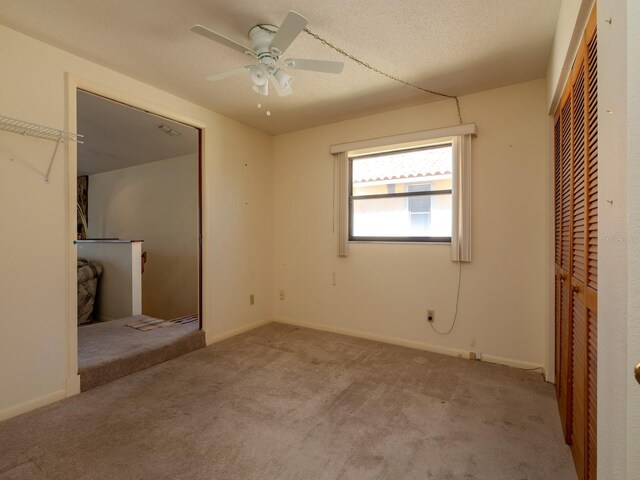 7085 Sunset Dr S Unit A, Saint Petersburg, FL 33707 - unfurnished bedroom with carpet, a closet, baseboards, and a ceiling fan