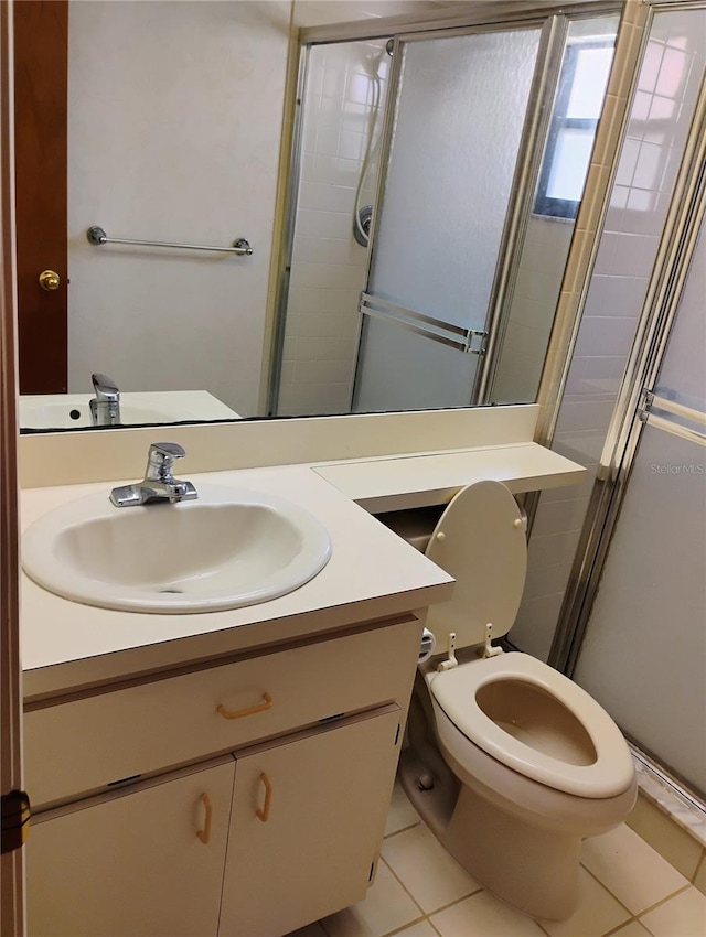 7085 Sunset Dr S Unit A, Saint Petersburg, FL 33707 - full bathroom featuring tile patterned floors, a stall shower, vanity, and toilet