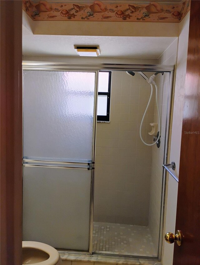 7085 Sunset Dr S Unit A, Saint Petersburg, FL 33707 - bathroom with a shower stall and toilet