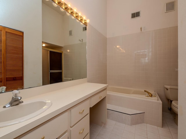 7085 Sunset Dr S Unit A, Saint Petersburg, FL 33707 - bathroom featuring toilet, a bath, tile patterned flooring, vanity, and tile walls