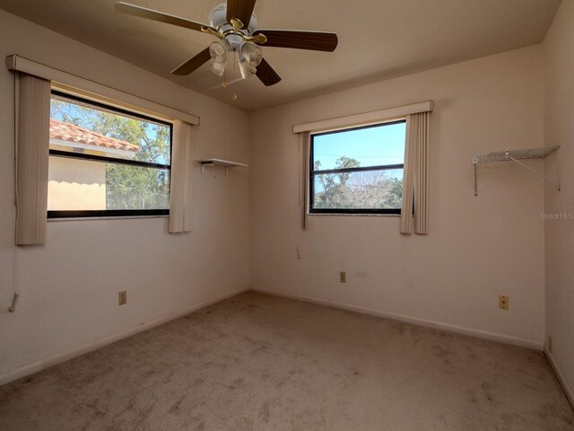 7085 Sunset Dr S Unit A, Saint Petersburg, FL 33707 - unfurnished room featuring light carpet, baseboards, and ceiling fan