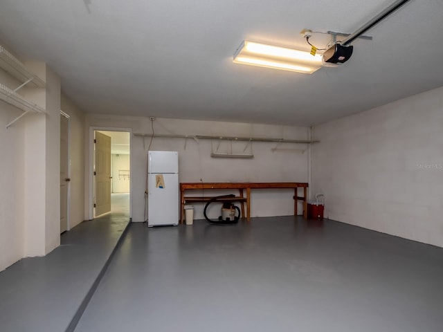 7085 Sunset Dr S Unit A, Saint Petersburg, FL 33707 - garage with freestanding refrigerator and a garage door opener