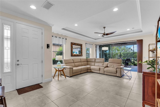 4610 Alexandria Ct, Palmetto, FL 34221 - living room with ceiling fan, visible vents, light tile patterned floors, and a raised ceiling