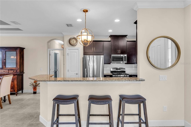 4610 Alexandria Ct, Palmetto, FL 34221 - kitchen featuring visible vents, baseboards, a kitchen bar, and stainless steel appliances
