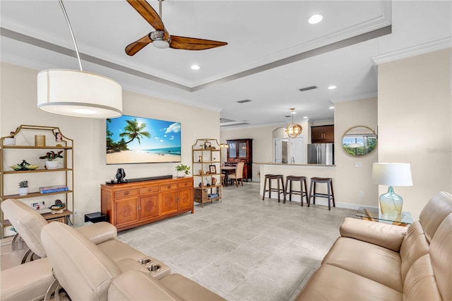 4610 Alexandria Ct, Palmetto, FL 34221 - living area with crown molding, a ceiling fan, recessed lighting, and a tray ceiling