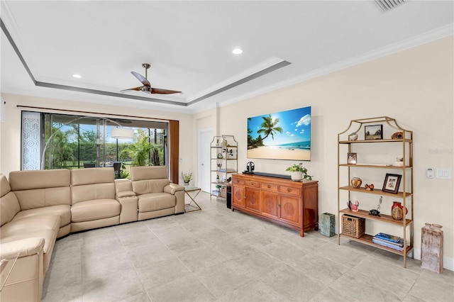 4610 Alexandria Ct, Palmetto, FL 34221 - living room featuring a ceiling fan, visible vents, ornamental molding, and a raised ceiling