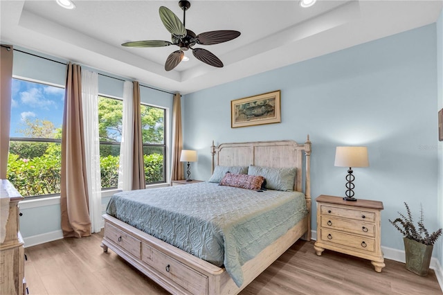 4610 Alexandria Ct, Palmetto, FL 34221 - bedroom with baseboards, recessed lighting, a raised ceiling, and light wood-style floors