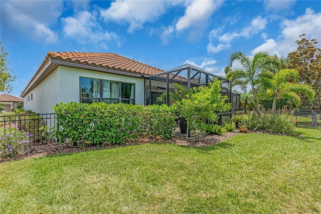 4610 Alexandria Ct, Palmetto, FL 34221 - back of property featuring a lanai, a tile roof, fence, a yard, and stucco siding