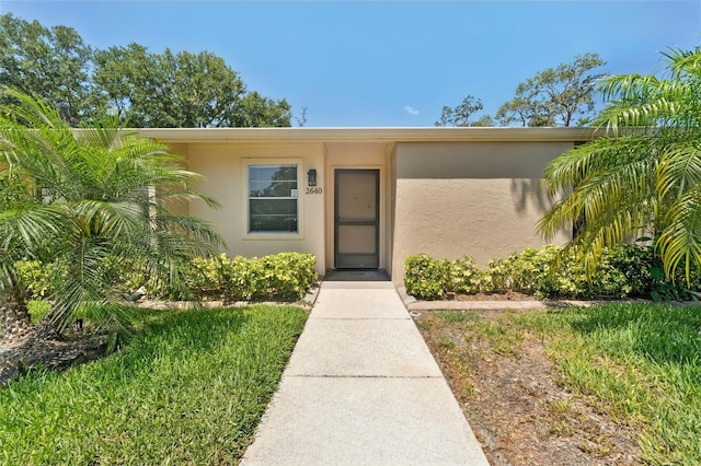 doorway to property with stucco siding