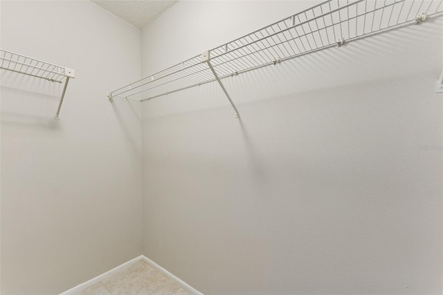 spacious closet featuring light tile patterned floors