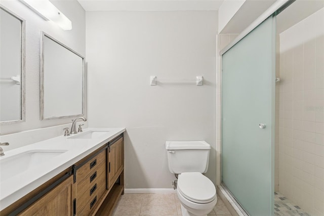 full bathroom featuring tile patterned flooring, a sink, toilet, and a shower stall