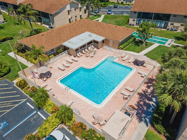 community pool featuring fence and a patio area