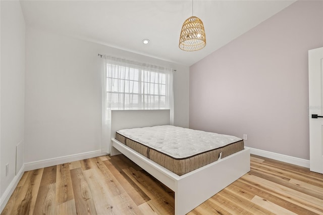 bedroom with light wood-type flooring, recessed lighting, baseboards, and a chandelier