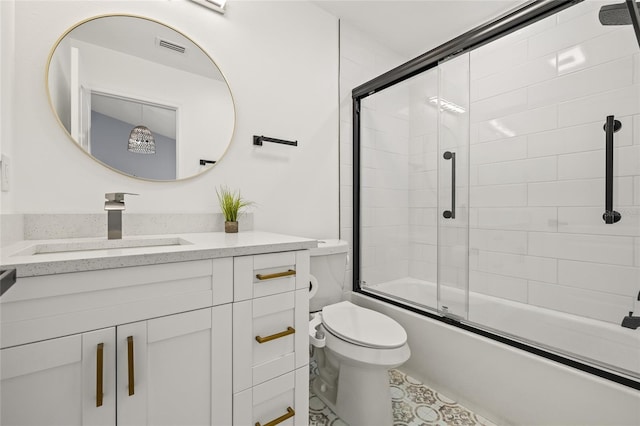 bathroom featuring visible vents, combined bath / shower with glass door, toilet, and vanity