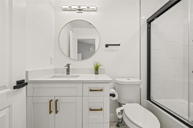 bathroom featuring vanity, bath / shower combo with glass door, and toilet