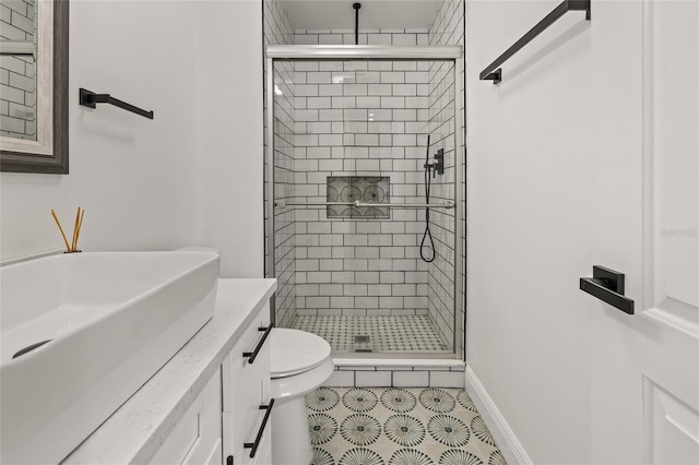 full bath featuring vanity, toilet, tile patterned flooring, and a stall shower