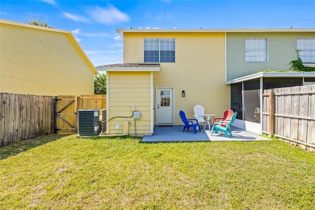 back of house with stucco siding, a fenced backyard, a gate, central air condition unit, and a patio