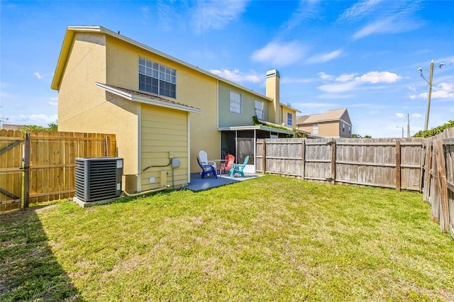 rear view of property featuring a lawn, central AC unit, a fenced backyard, a patio, and stucco siding