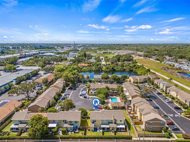 birds eye view of property with a water view and a residential view