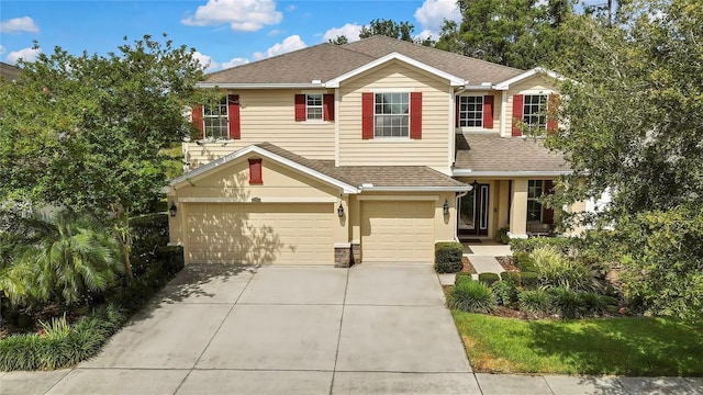 view of front of home featuring a garage, stucco siding, concrete driveway, and roof with shingles