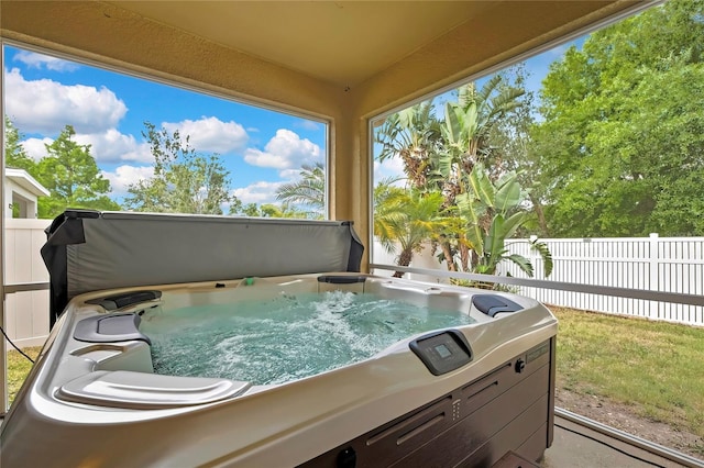 exterior space featuring a hot tub and fence