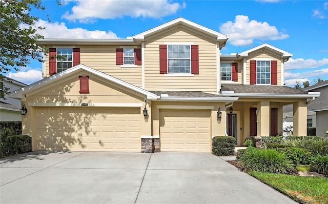 view of front of home featuring an attached garage, driveway, and a shingled roof