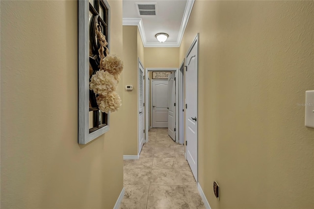 hall with crown molding, light tile patterned flooring, baseboards, and visible vents