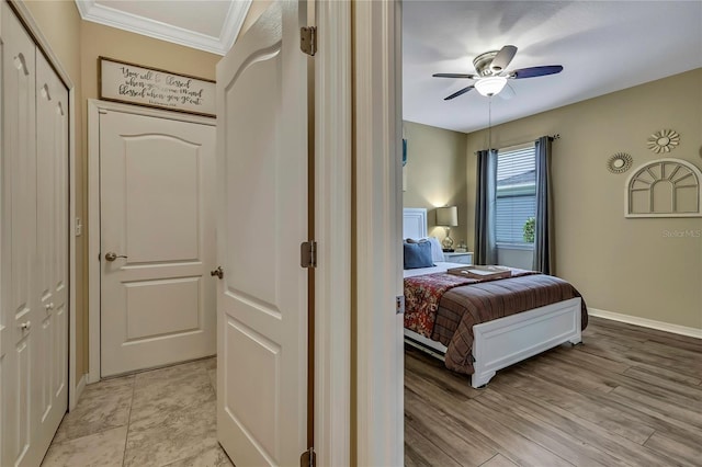 bedroom with a ceiling fan, baseboards, and ornamental molding