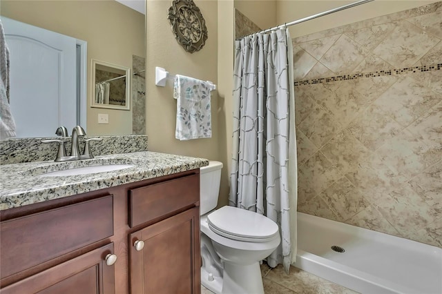 bathroom with vanity, toilet, tile patterned floors, and a stall shower