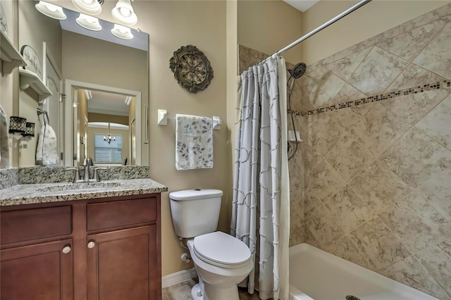 bathroom with vanity, baseboards, toilet, and an inviting chandelier