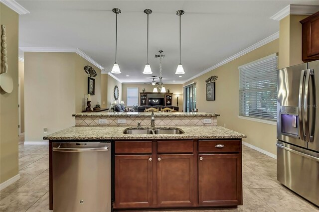 kitchen with backsplash, appliances with stainless steel finishes, a sink, light tile patterned floors, and open floor plan