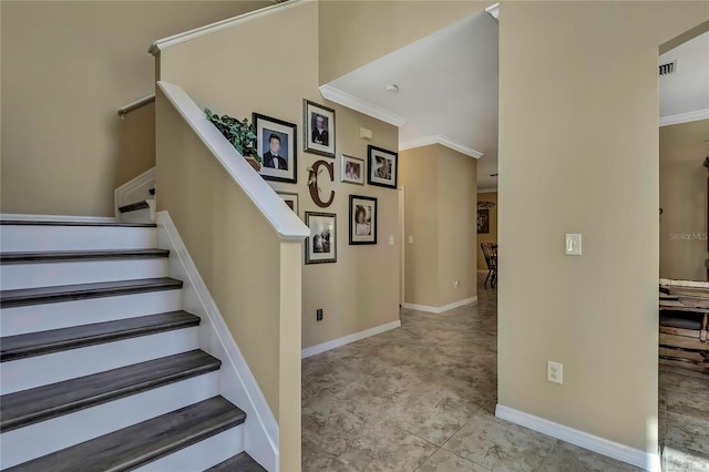 stairs featuring baseboards, visible vents, ornamental molding, and tile patterned flooring
