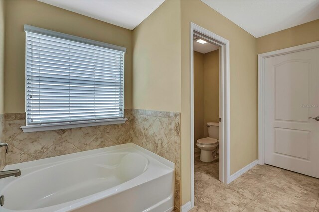 full bathroom featuring toilet and a bath