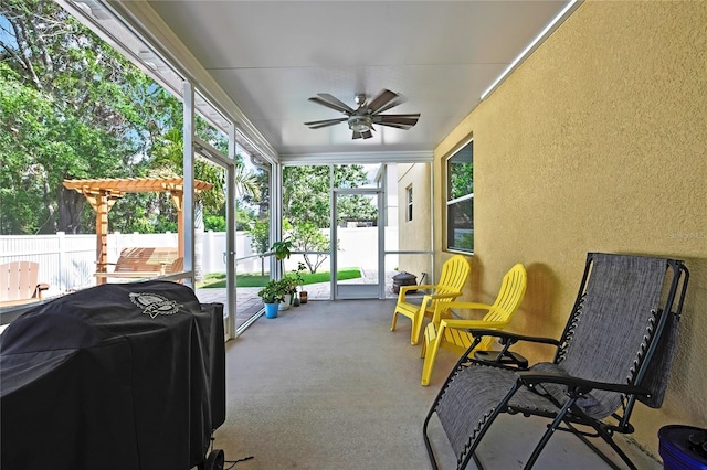sunroom featuring ceiling fan and a healthy amount of sunlight