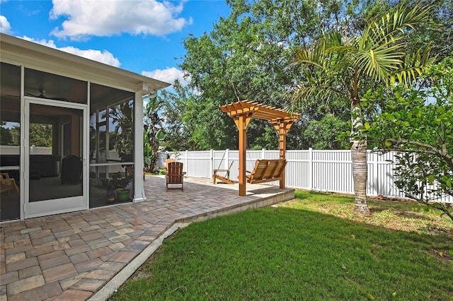 view of yard featuring a sunroom, fence, and a patio area