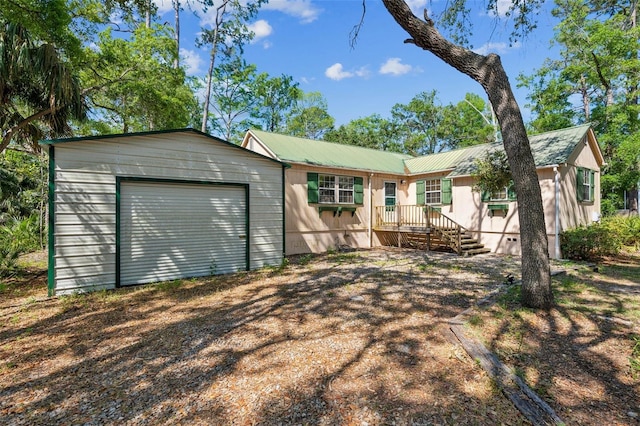 526 Kings Creek Cir, Steinhatchee, FL 32359 - back of house featuring an attached garage and metal roof
