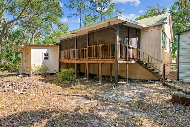 526 Kings Creek Cir, Steinhatchee, FL 32359 - back of property featuring a storage unit, stairs, a sunroom, an outdoor structure, and metal roof
