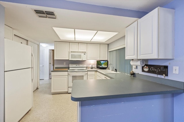 kitchen featuring white appliances, white cabinetry, visible vents, and a sink