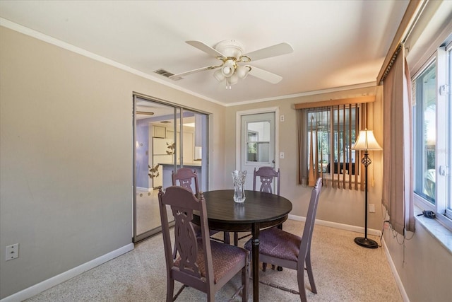 dining space featuring ceiling fan, light colored carpet, baseboards, visible vents, and ornamental molding