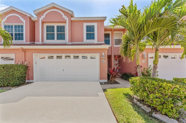14506 Alejo Ct, Seminole, FL 33776 - view of front of property with stucco siding, driveway, and an attached garage