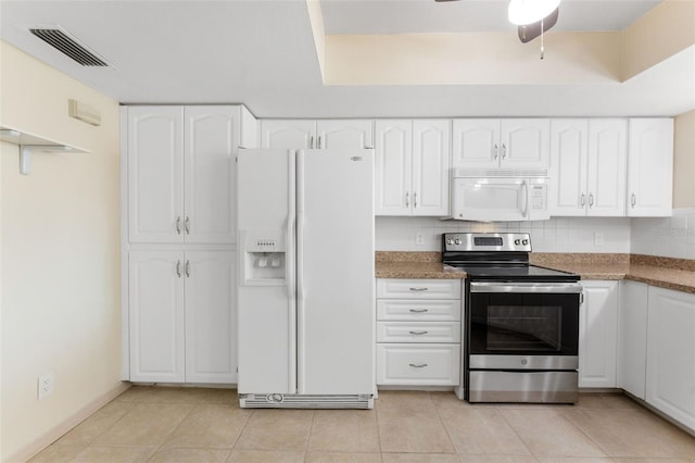 14506 Alejo Ct, Seminole, FL 33776 - kitchen featuring white appliances, white cabinetry, ceiling fan, light tile patterned flooring, and stone counters