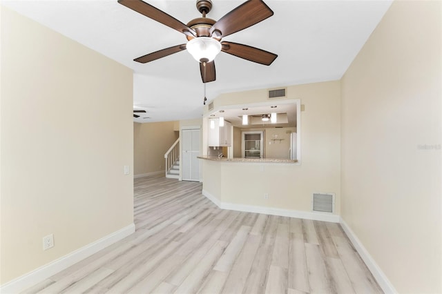 14506 Alejo Ct, Seminole, FL 33776 - unfurnished living room featuring light wood-type flooring, stairway, baseboards, and ceiling fan