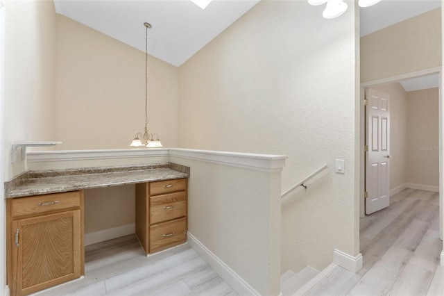 14506 Alejo Ct, Seminole, FL 33776 - bathroom with a chandelier, wood finished floors, lofted ceiling, vanity, and baseboards