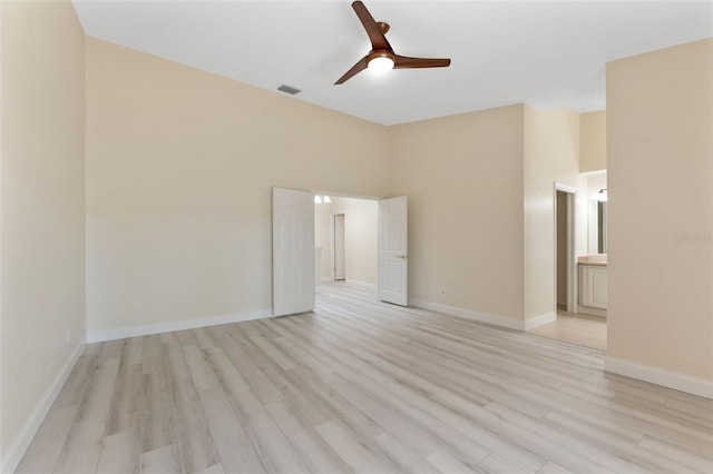 14506 Alejo Ct, Seminole, FL 33776 - spare room with light wood-type flooring, ceiling fan, and baseboards