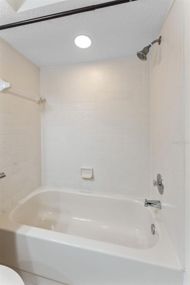 14506 Alejo Ct, Seminole, FL 33776 - bathroom with  shower combination, a textured ceiling, and toilet
