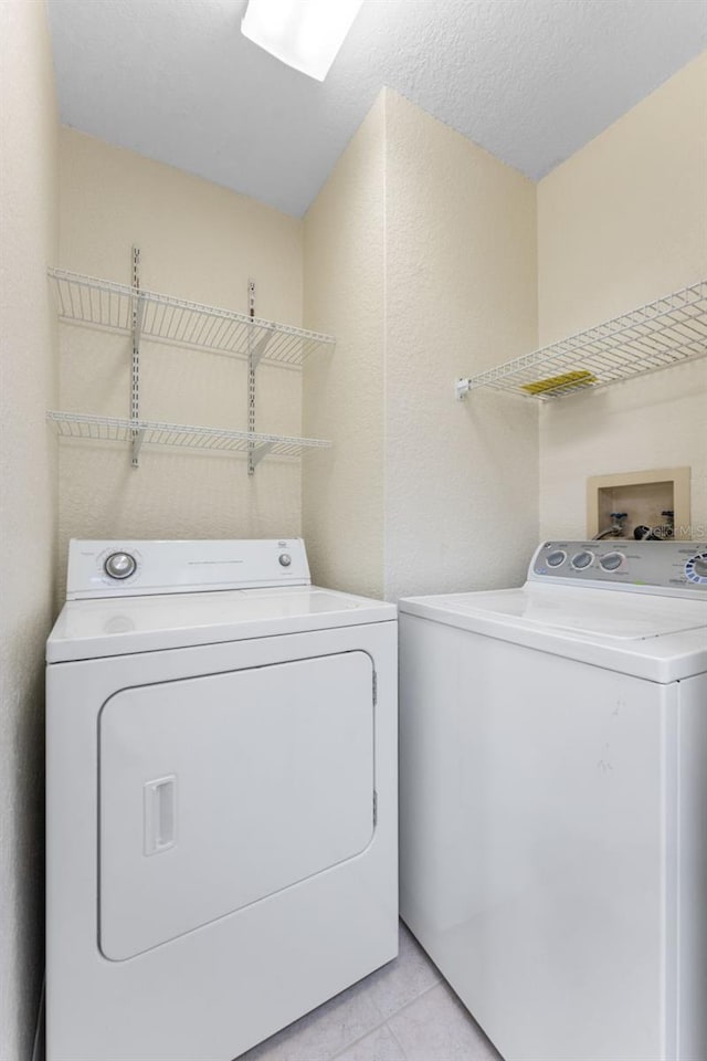 14506 Alejo Ct, Seminole, FL 33776 - laundry room featuring washing machine and dryer and light tile patterned floors