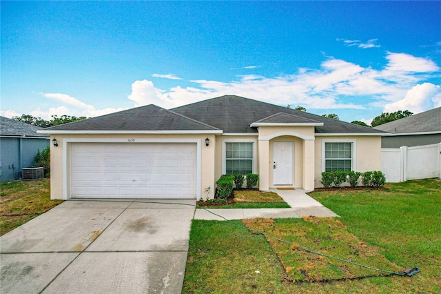 1639 Saddlehorn Dr, Lakeland, FL 33810 - ranch-style house featuring a garage, a front lawn, stucco siding, central AC unit, and concrete driveway